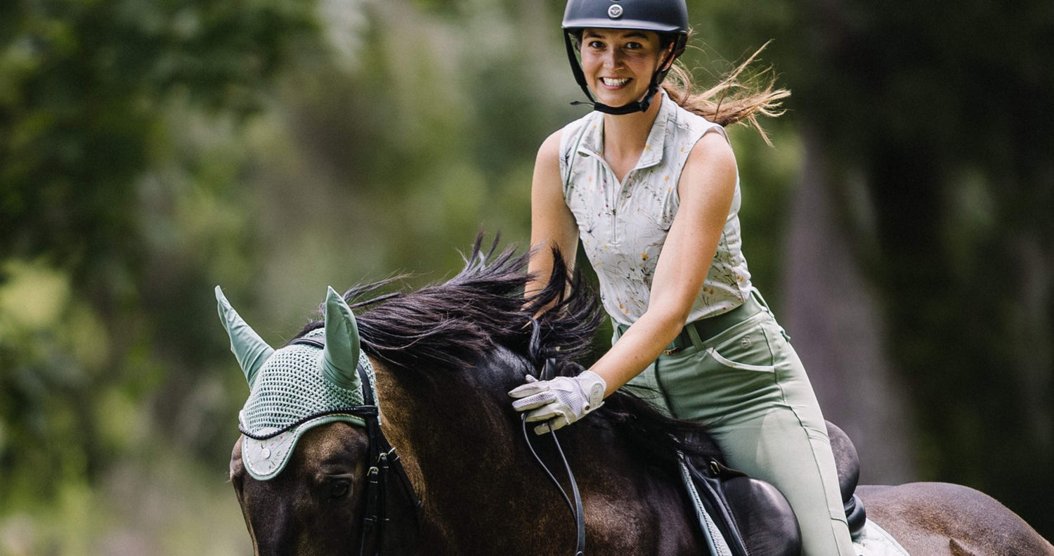 summer riding breeches, equestrian breeches, summer breeches, blond girl rides dark bay horse wearing sage green matching riding clothes