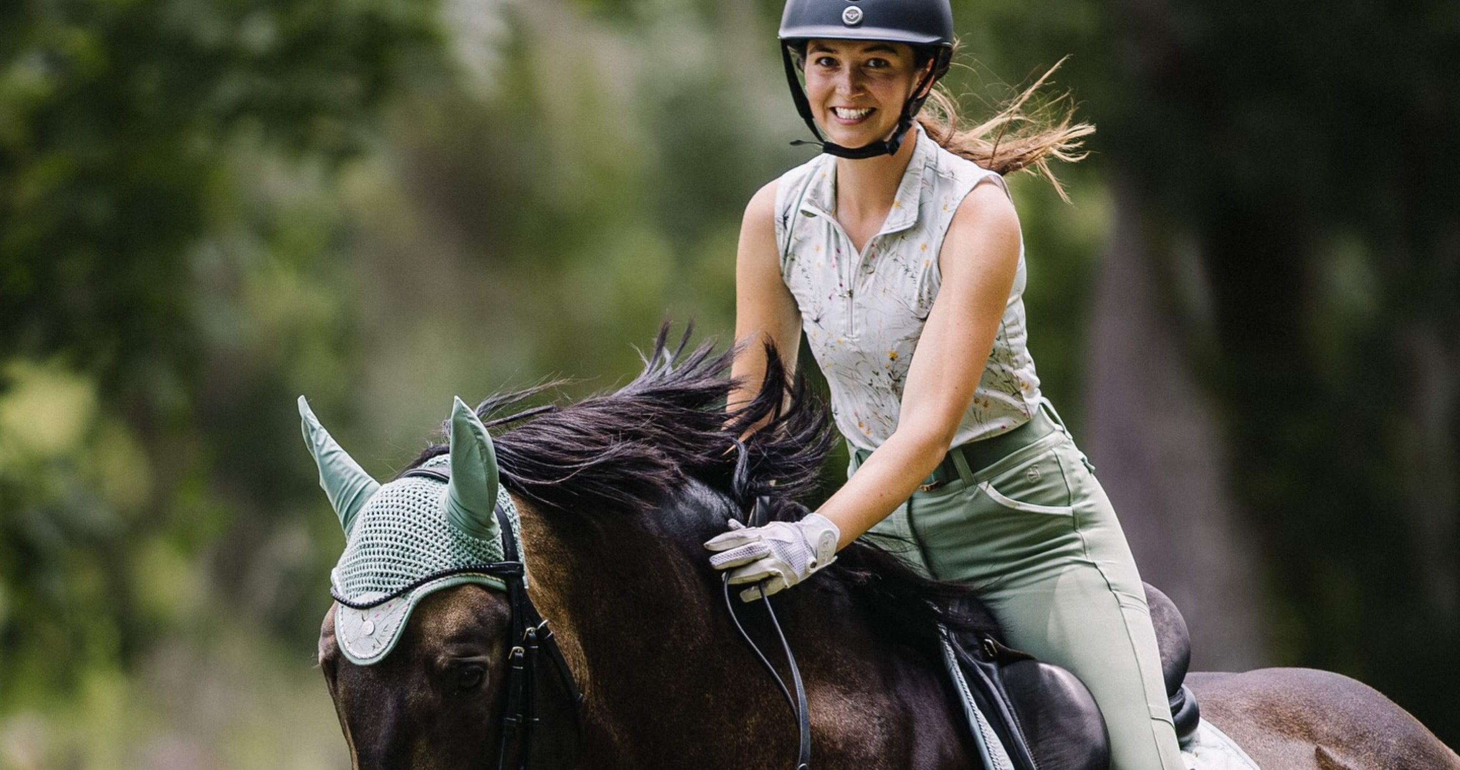 summer riding breeches, equestrian breeches, summer breeches, blond girl rides dark bay horse wearing sage green matching riding clothes