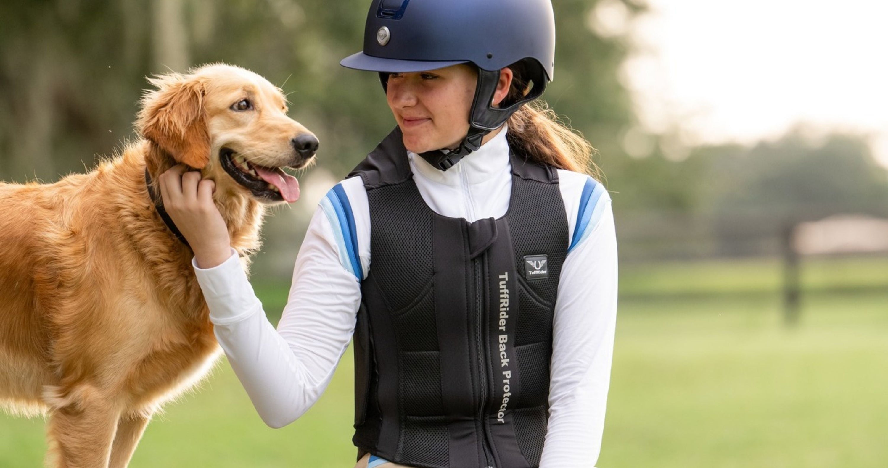 Equestrian safety vest, Horse riding body protector, girl wearing tuffrider back protector sits with golden retriever