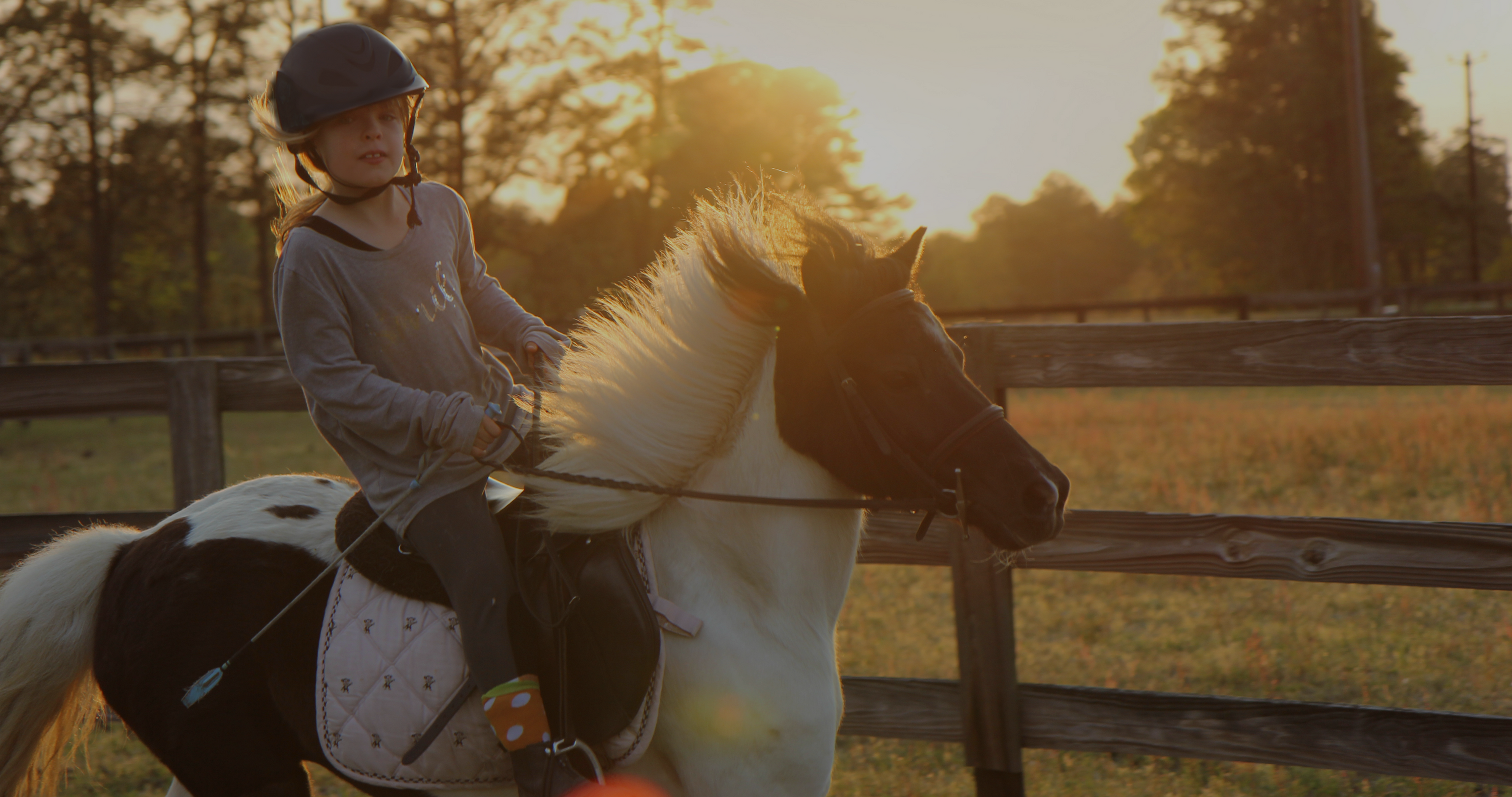 child riding at summer horse camp